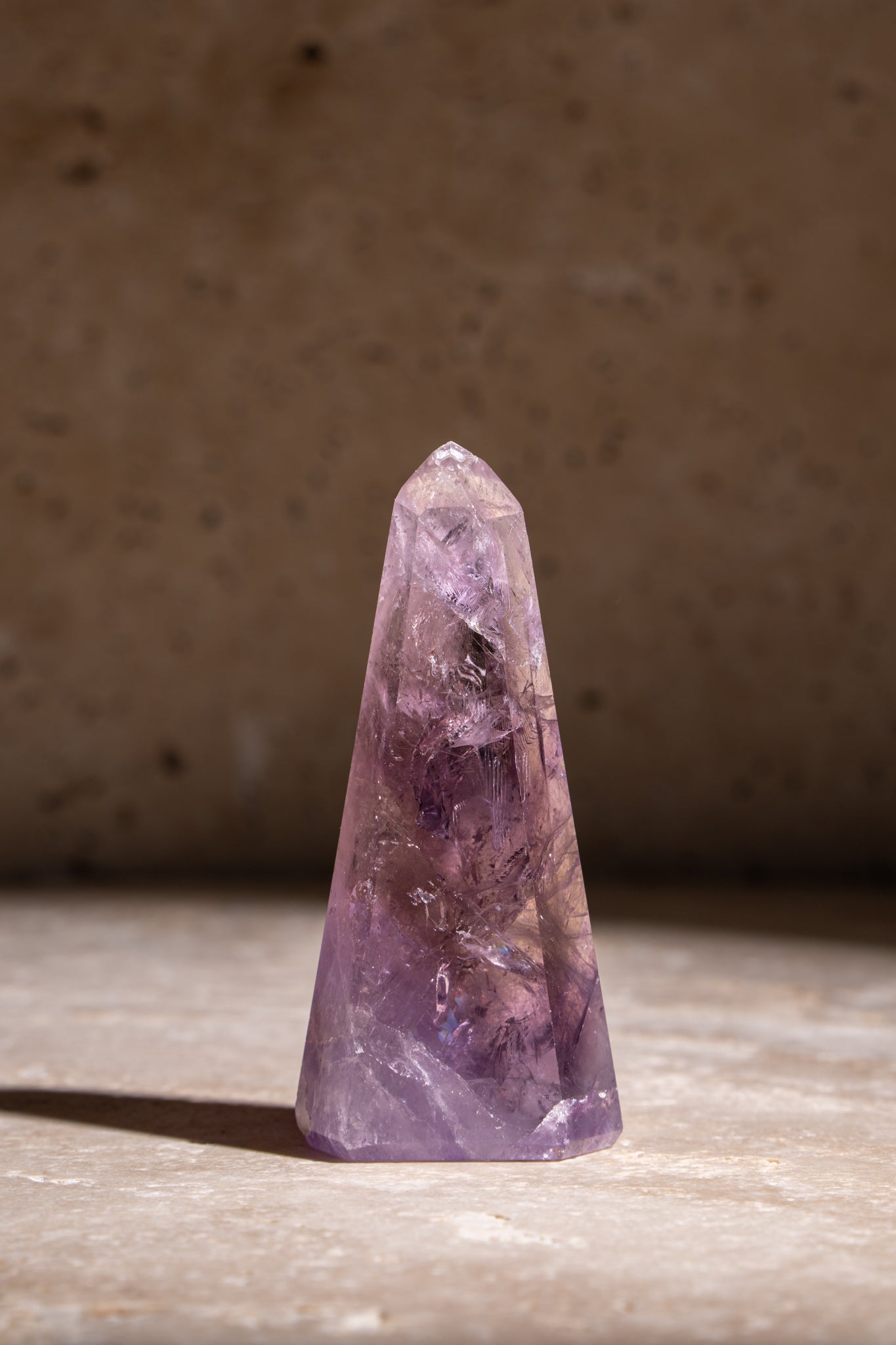 A beautiful natural Amethyst crystal tower showcasing vibrant purple hues and unique inclusions, ideal for spiritual healing and energy work.