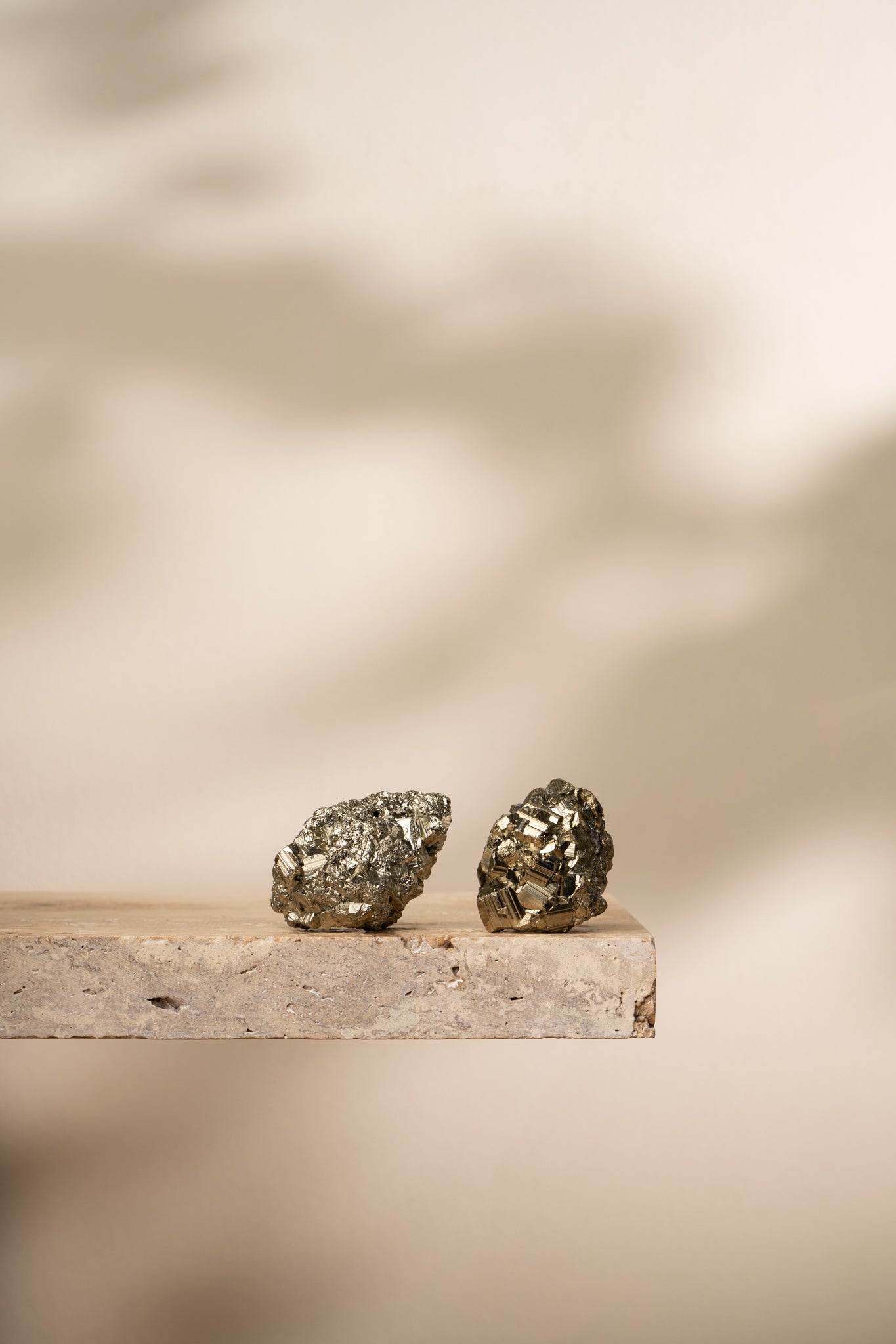 A raw Pyrite cluster with metallic gold cubic structures, showcasing its natural formation and shimmering texture.