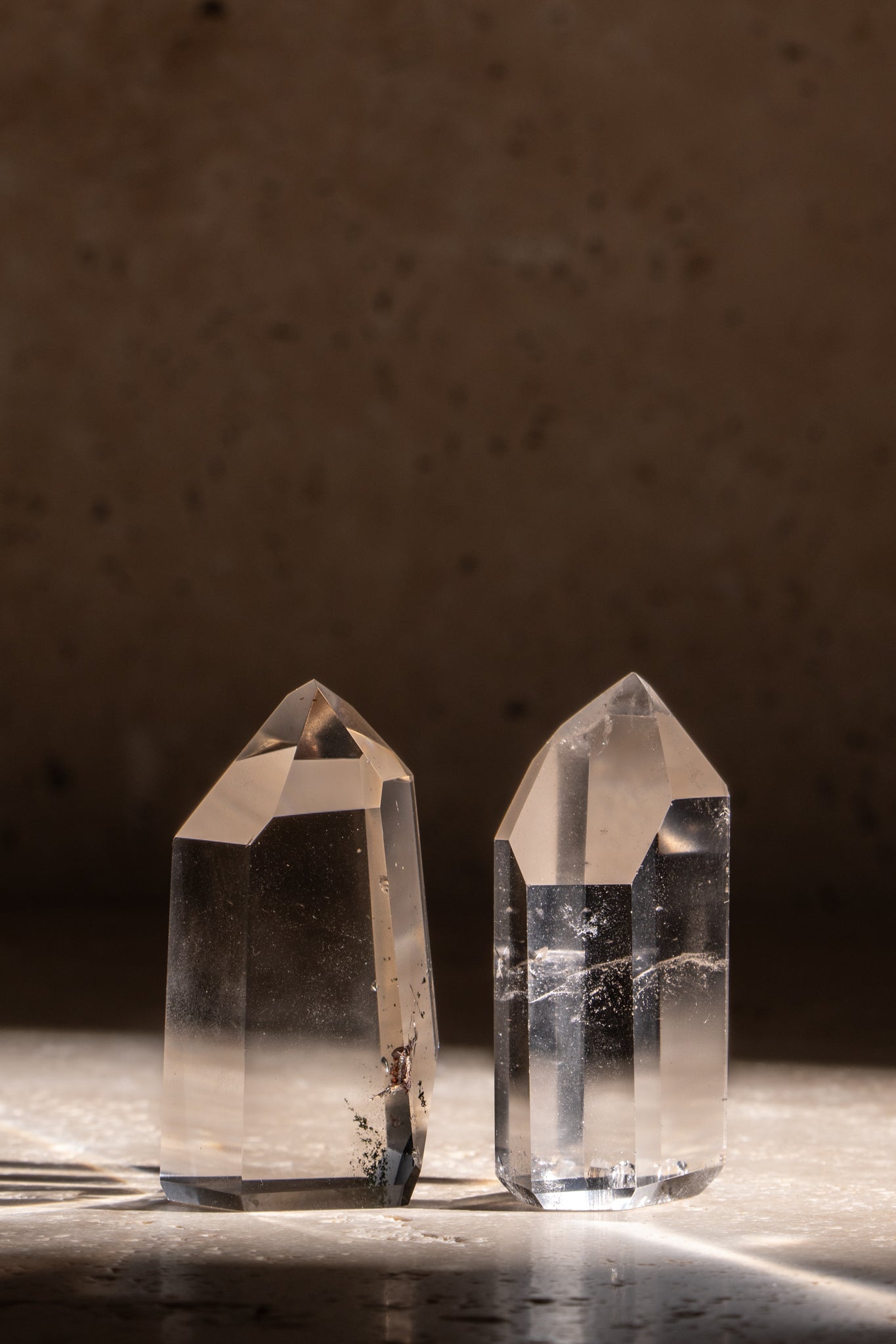 A set of two polished AAA quality Clear Quartz towers, featuring sharp, faceted tips with natural inclusions and exceptional clarity.